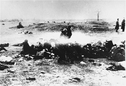 Jewish women huddle together prior to their execution on a beach near Liepaja